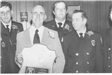 Black and White Photo of a Fire Employee Receiving an Award 1