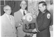 Black and White Photo of a Fire Employee Receiving an Award 3