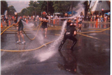 Firefighters Spraying Hoses in the Street