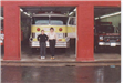 Fire Staff Taking a Picture in Front of a Fire Engine Parked in the Station Garage