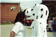 Woman Looking Into the Mouth of a Fire Dalmatian Mascot Character