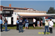 People Line up in Front of a Fire Safety Trailer