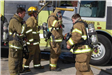 Four Firefighters Suited up at the Scene of the Fire