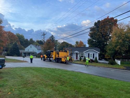 Workers cracksealing a neighborhood street