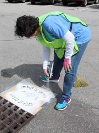 Volunteers stencil catch basins on Earth Day 2018