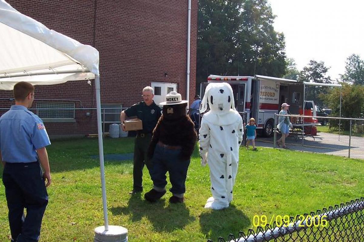 Smokey the Bear and Fire Dalmatian Mascot Characters Attending the Event