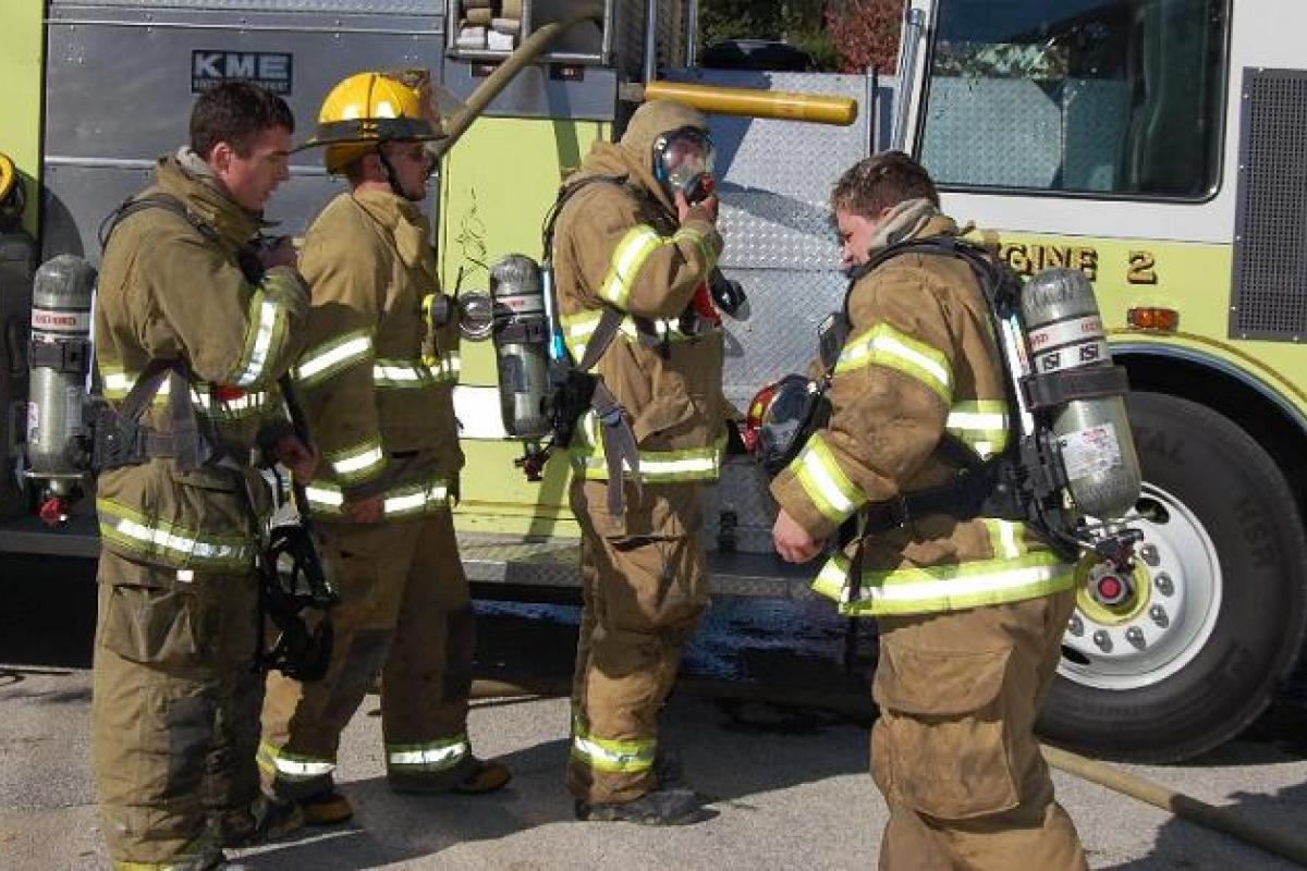Four Firefighters Suited up at the Scene of the Fire