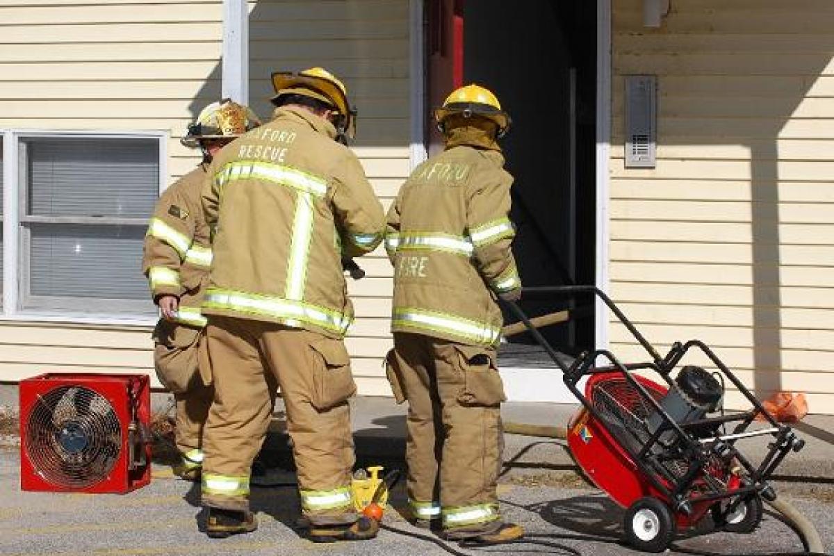 Three Firefighters at the Front Door of the House Fire
