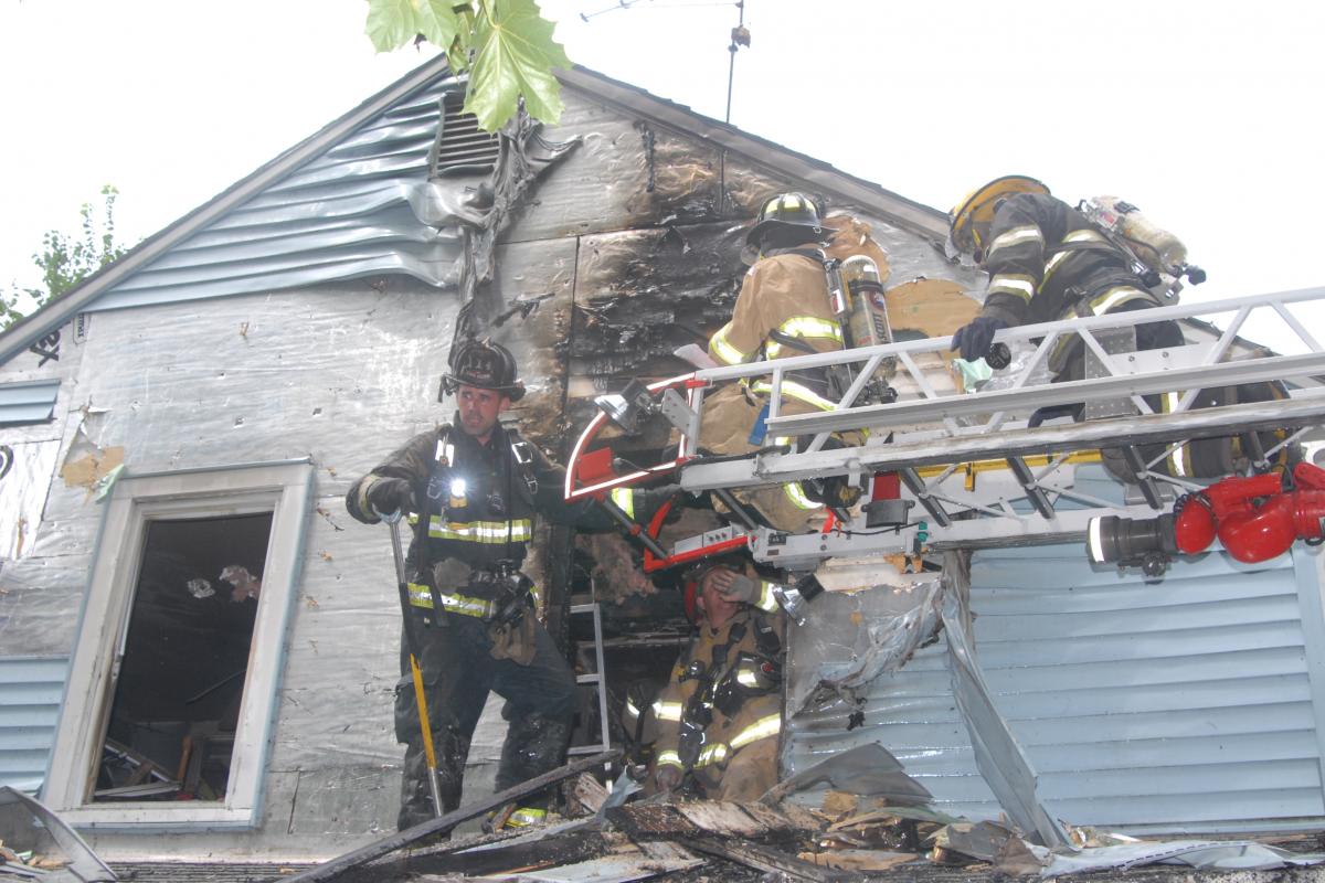 Fire Crew of Trainees Entering the Second Story of a Mock Structure Fire